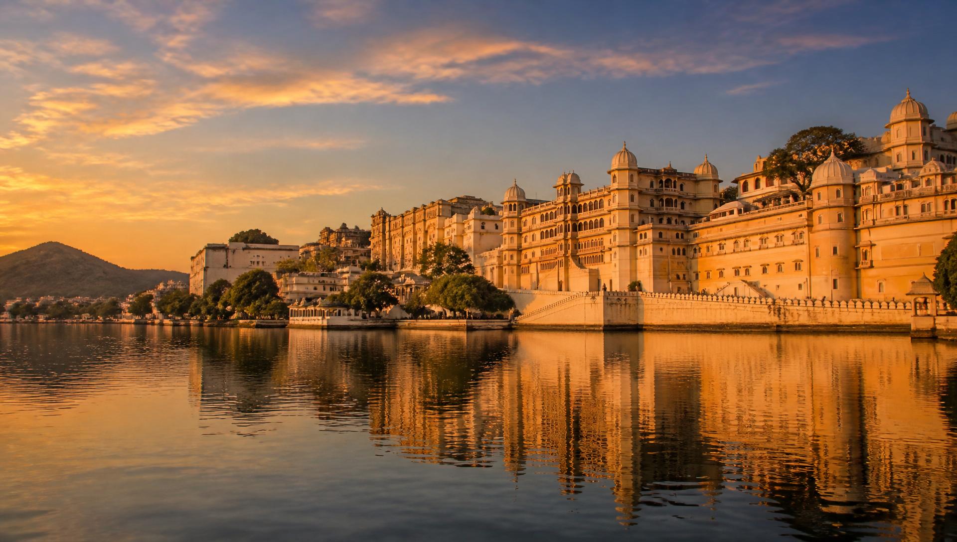 Udaipur City Palace reflected in Lake Pichola at sunset